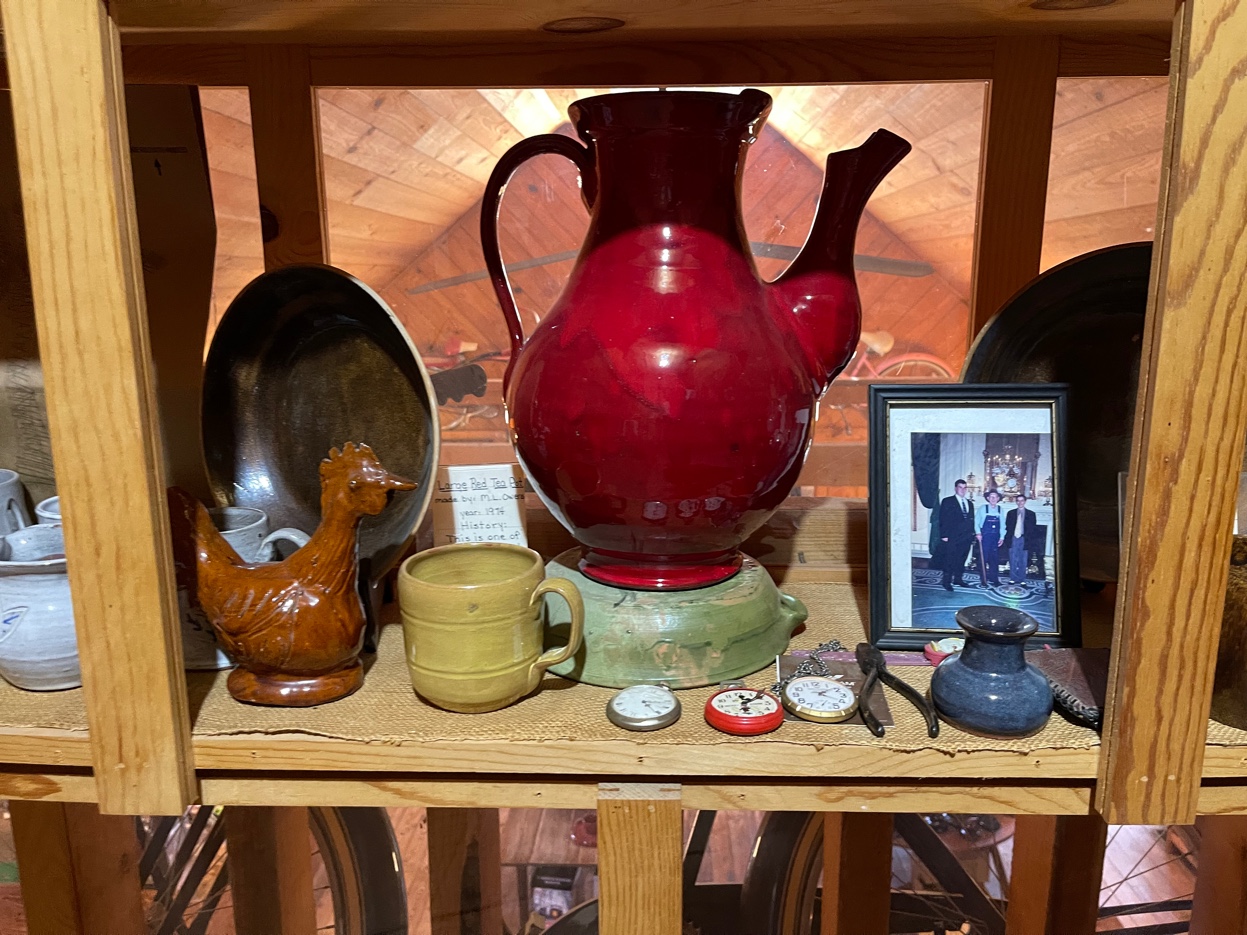 M.L. Owens shop shelf with large red teapot 1976